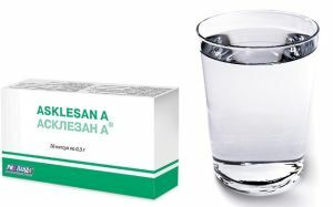 a glass of water and tablets