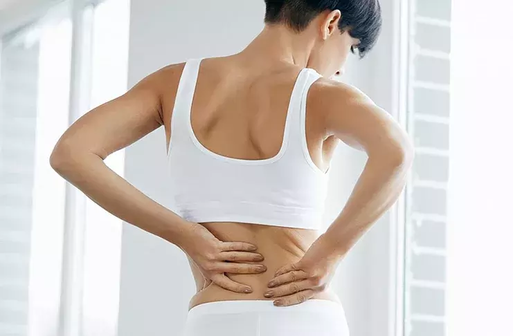 Why does the lower back (back) hurt before menstruation: aches, aches (reasons)